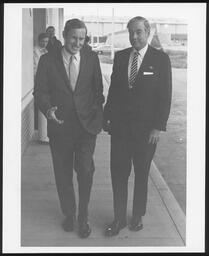 Meetings, Rep. James B. Kelly and Gov. Scranton walk down sidewalk
