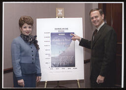 Rep. John Barley and Rep. Mary Ann Dailey stand in front of a poster board "Tax Relief 1995-2000"
