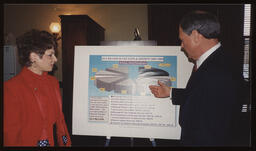 Rep. John Barley and Rep. Mary Ann Dailey stand in front of a poster board "2.6 Billion in Tax Cuts and Credits 1995-1999"