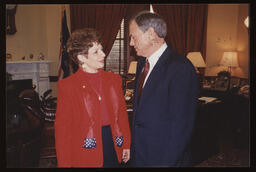 Rep. John Barley and Rep. Mary Ann Dailey standing in Rep. Barley's office, facing each other in conversation