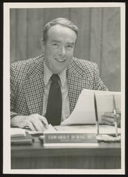 Rep. Burns seated at his office desk