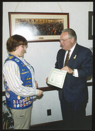 Girl Scout Amanda Berry receiving an award from Rep. Thomas Tangretti