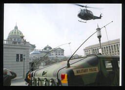 A view of the helicopter known as "America's Huey - 091" flying into Commonwealth Avenue.